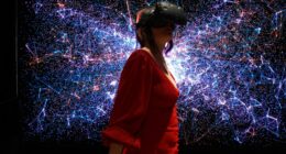 a woman in a red dress wearing a virtual reality headset