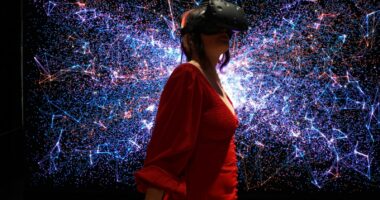a woman in a red dress wearing a virtual reality headset